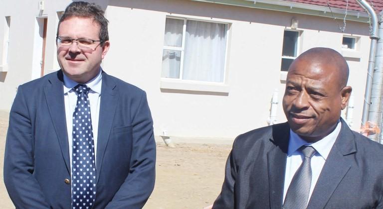 LSP Managing Director Andre Bothma and Health Minster Nyapane Kaya stand behind the clinic building