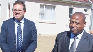 LSP Managing Director Andre Bothma and Health Minster Nyapane Kaya stand behind the clinic building